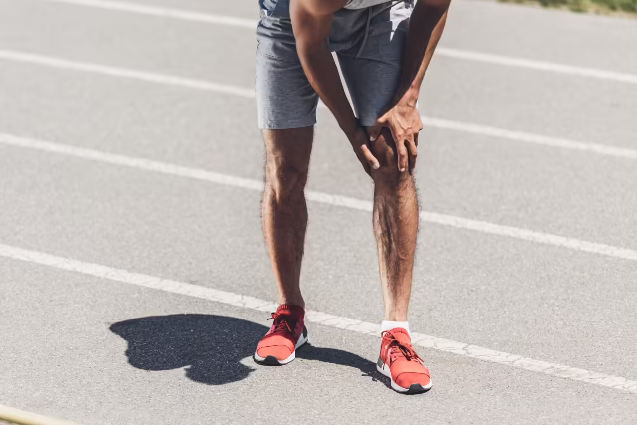 man with knee pain on running track 2026 03 13 01 20 47 utc